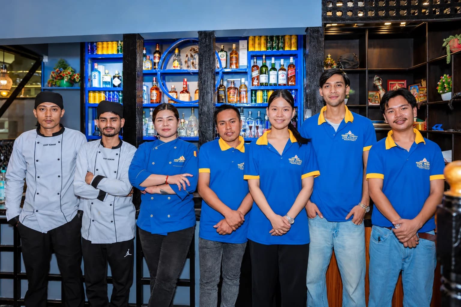 The Swad Satkar team at the bar: the kitchen in chef whites, the floor team in blue